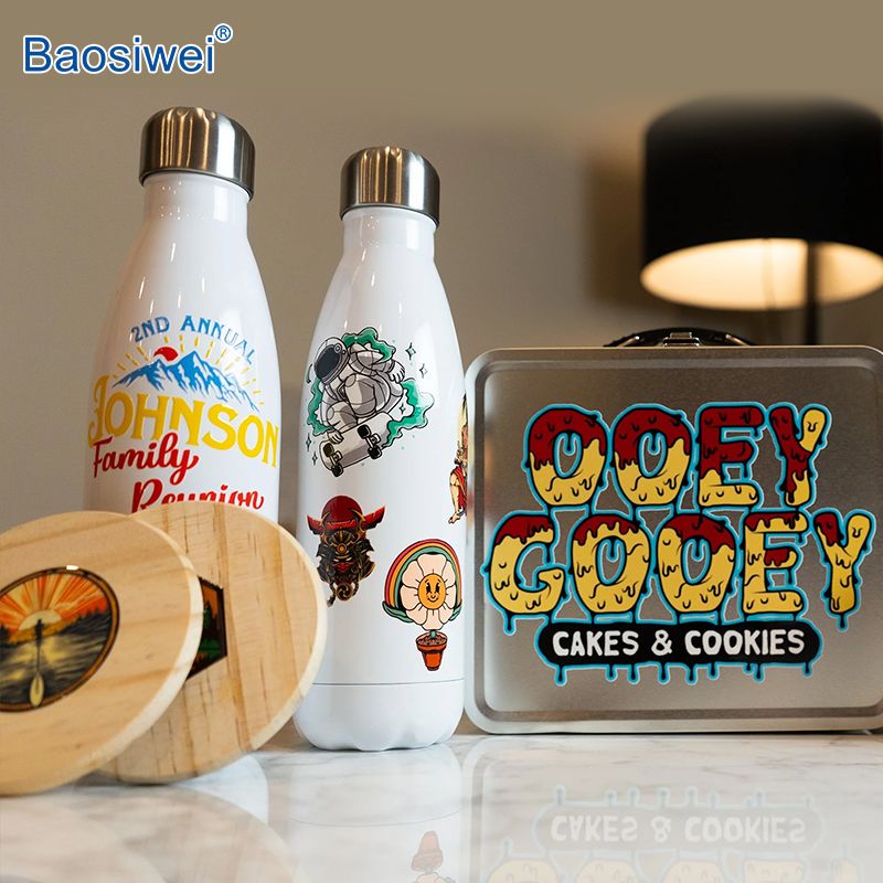 Stainless steel bottles, wooden coasters, and metal lunch box with colorful UV DTF crystal labels, showcasing Baosiwei printer's strong adhesion and multi-surface compatibility.