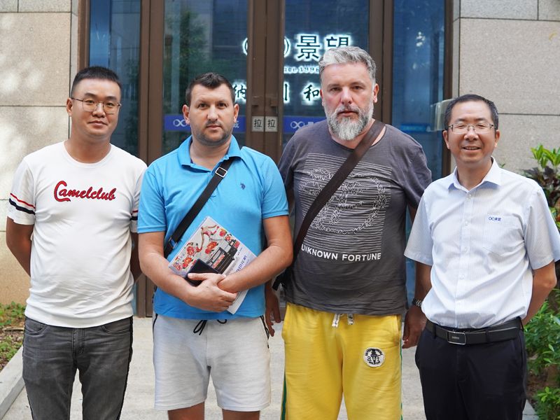 Baosiwei international distributors and sales team in front of headquarters, showcasing global cooperation and support program