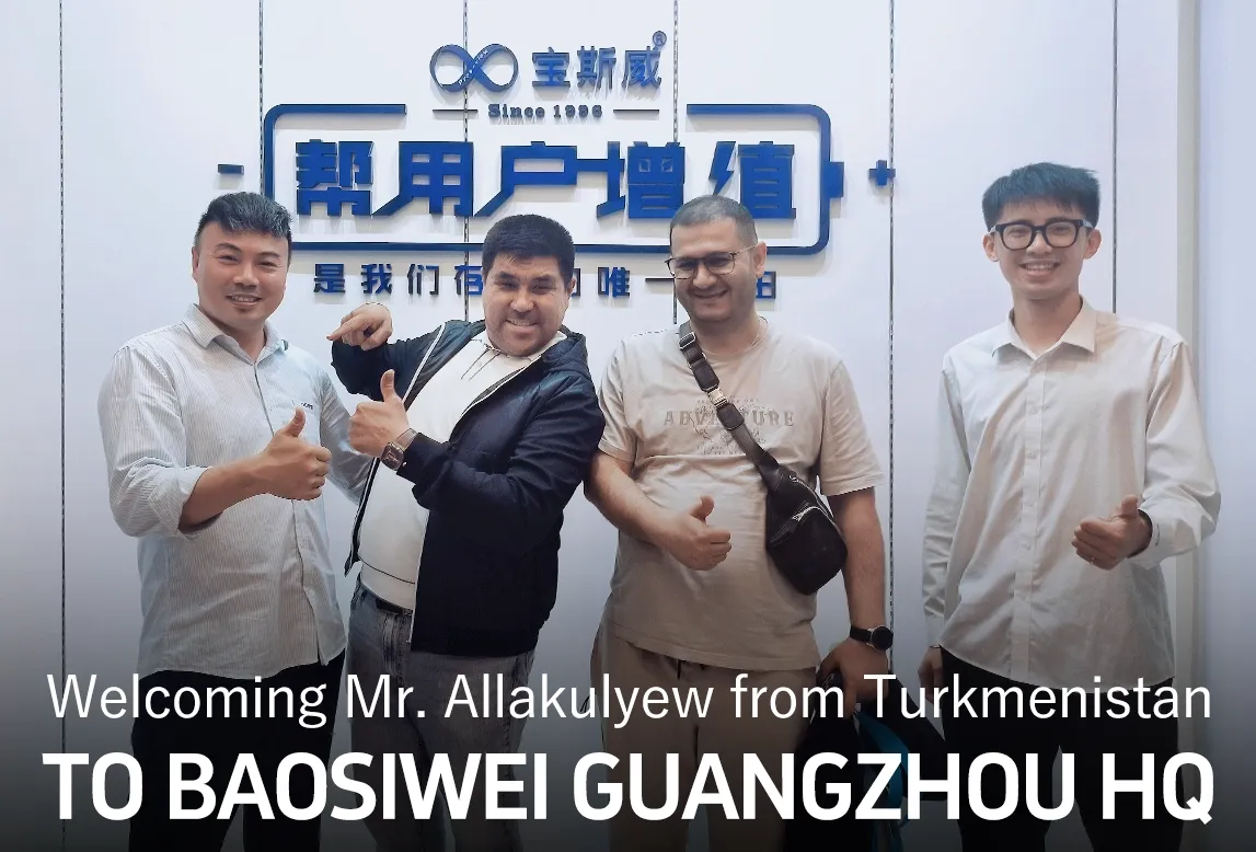 International customer Mr. Allakulyew from Turkmenistan visiting Baosiwei Guangzhou headquarters, posing for a photo with the Baosiwei team in the company reception area.