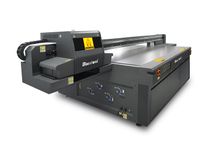 Side view of Baosiwei JW-2513M UV printer featuring Ricoh G5/G6 printheads for embossed and varnish effects